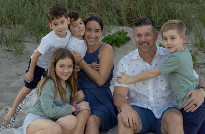 Cheryl and Ronnie Fairlie with their four children on a South Florida beach